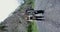 The Caucasus. A couple of hikers stands on road among rocks and looks at camera