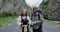 The Caucasus. A couple of hikers stands on road among rocks and looks at camera