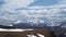 Caucasus mountains. Paraglider flies among the snow-capped mountains.