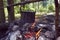 Cauldron boils on the fire in the forest. In marching a saucepan preparing food. Adventure tourism, camping, cooking on a fire