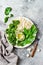 Cauliflower rice Buddha bowl with kale, avocado, seeds, snow peas and tahini dressing.