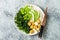 Cauliflower rice Buddha bowl with massaged kale, tofu, avocado and edamame beans. Vegan poke bowl.