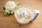 Cauliflower shredded in a food processor for healthy low carb pizza crust or as vegetable rice replacement on a wooden kitchen