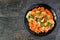 Cauliflower steak with sweet potato mash, top view on a dark stone background