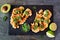 Cauliflower steaks above view on a slate platter, healthy plant based meat substitute concept