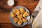 Cauliflower wings food. Pieces of flour-fried cauliflower with vegan sauces on a plate. Wooden background. Vegetarian food