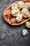 Cauliflower on wooden plate and grey concrete