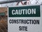 Caution construction site sign on metal fence