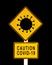 Caution Covid-19 written on a yellow warning danger roadsign. Coronavirus covid pandemic concept