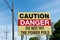 Caution Danger Sign Near Power Pole