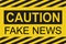Caution fake news sign