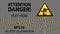 Caution, low-noticeable obstacle. Safety sign. Yellow triangle with black image on the pole and protecting ribbons. Gray