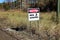 A caution men working sign beside a road