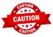 caution round ribbon isolated label. caution sign.