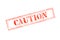 `CAUTION ` rubber stamp over a white background
