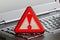 Caution sign on black laptop computer virus detected alert hacking piracy