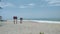 Caution sign and a lifebelt hanging on a pole on the beach