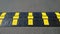 Caution speed bump with Illuminating yellow rectangles. Sleeping policeman. Gray grunge asphalt background. Road safety regulation