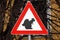 Caution squirrel crossing sign, red triangle with squirrel