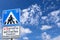 Caution student crossing signboards on beautiful blue sky with clouds in the clear day.