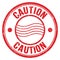 CAUTION text written on red round postal stamp sign