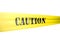 Caution tickertape style cordon on yellow tape on white