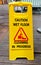 Caution wet floor sign cleaning in progress sign on wood floor