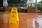 Caution wet floor yellow sign warning while it raining outside. Safety first and need to be clean. protect from injury slippery