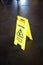 Caution yellow sign for warning, falling in love, on a floor