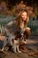 Cavalier King Charles Spaniel dog and a girl are together in the park enjoying beautiful autumn day