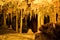 Cave dark interior with light, stalactites and stalagmites