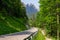 Cave Del Predil - High alpine road along Lake Predil with panoramic view of majestic mountain peak Cinque Punte