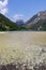 Cave Del Predil - Scenery of Lake Predil with panoramic view of majestic mountain peak Cinque Punte