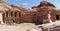 Cave dwelling, which is still used today as a storage room and recreation room, with Al-Deir Monastery in the background in the mo