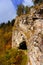 Cave entrance under a sheer cliff