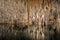 Cave with lake, stalactites and stalagmites, long exposure