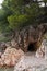 Cave in the Milocher park with a view to the King`s Beach in Sveti Stefan