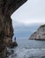 Caves of Zinzulusa, near Castro on the Salento Peninsula in Puglia, Italy. Person in silhouette stands on the gang plank