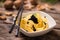 Caviar pasta tagliatelle on a white bowl with wooden background