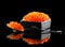 Caviar in a spoon. Salmon caviar in a bowl over black. Closeup trout caviar