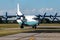 Cavok Air Antonov An-12 cargo plane at airport apron with marshaller. Air freight and shipping. Aviation and aircraft