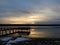 Cayuga Lake pier golden hour reflection in winter solstice