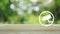 Cctv camera flat icon on wooden table over blur green tree in park, Business security and safety online concept