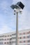 CCTV Security camera with loudspeakers and a megaphone against the sky and an apartment building in Russia