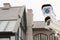 The CCTV security camera operating on luxury roof house blur background.