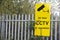 CCTV yellow sign on security railing