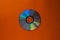 Cd compact disc on  a orange background top view with copy space