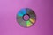 Cd compact disc on a purple-lilac background top view  with copy space