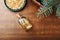 Cedar oil in glass bottle, pine nuts, brunches on a wooden broun background. Top view with copy space