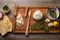 cedar plank with ricotta cheese and grill tools nearby